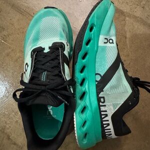 On Running Shoes with Teal and Black Accents